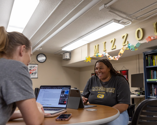 Students sitting and laughing.