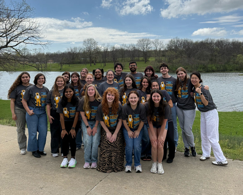 Students in front of body of water.