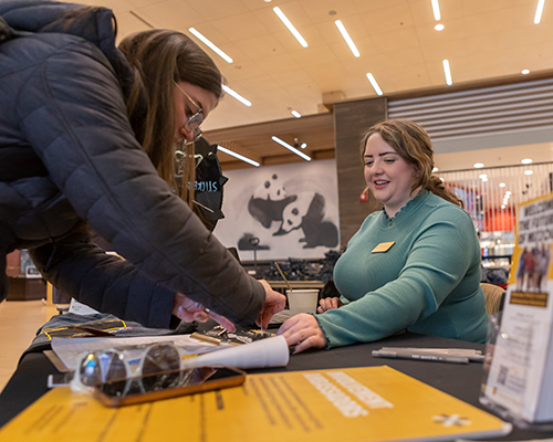 Student talking to a vendor at the Resource Fair.